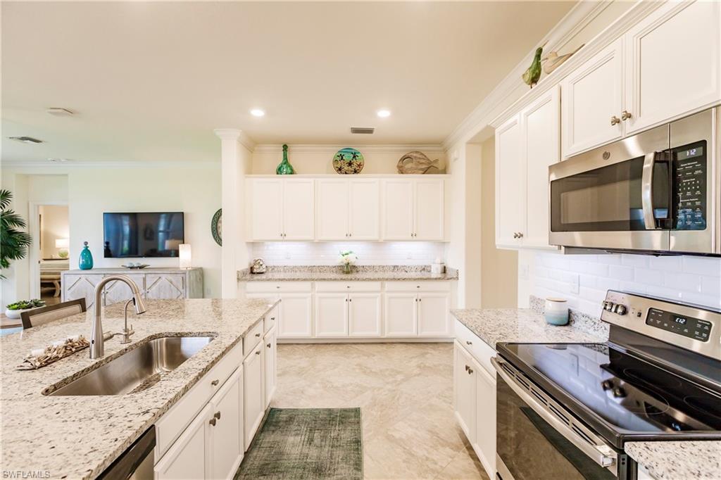 14360 Vindel Circle Fort Myers, FL 33905 - Photo 7 of 41 a kitchen with stainless steel appliances granite countertop a sink and a stove
