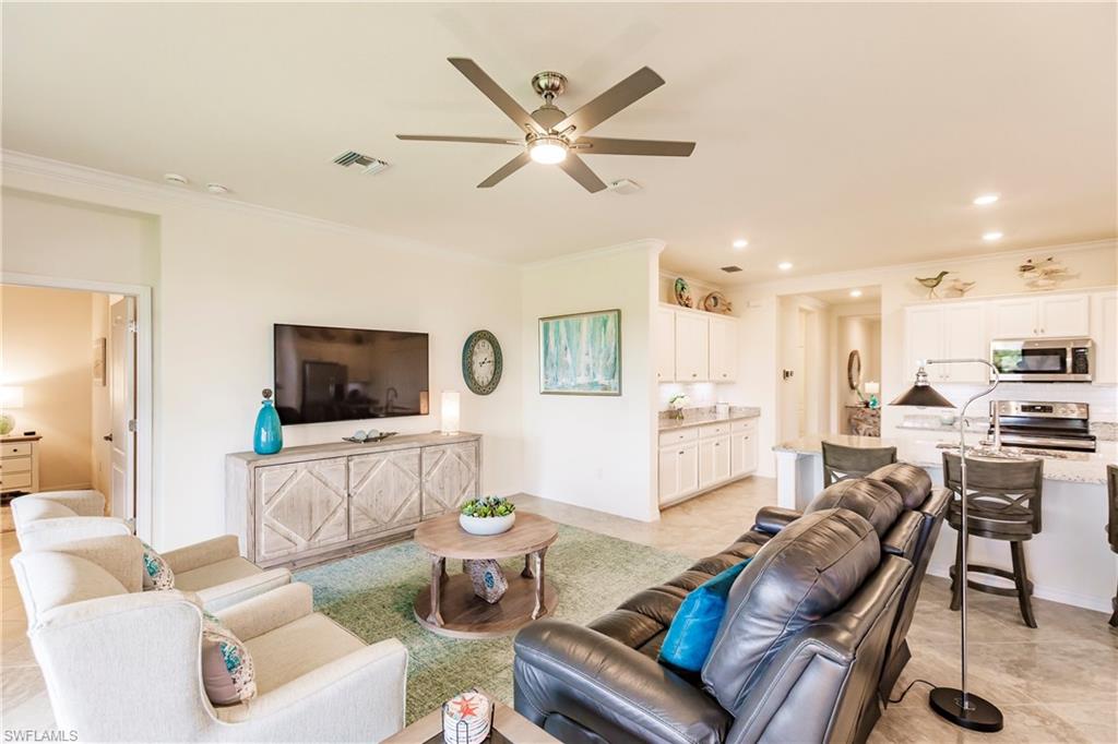 14360 Vindel Circle Fort Myers, FL 33905 - Photo 9 of 41 a living room with furniture kitchen view and a flat screen tv