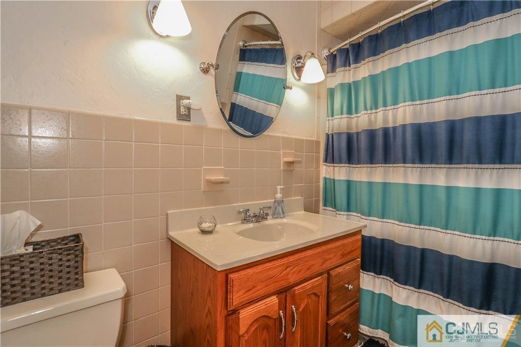 35 Stiles Road Edison, NJ 08817 - Photo 21 of 25 a bathroom with a sink and a mirror