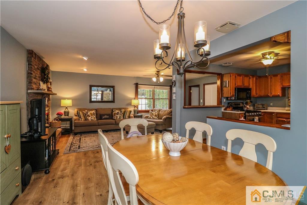 35 Stiles Road Edison, NJ 08817 - Photo 5 of 25 a very nice looking open dining room with kitchen island furniture a chandelier and a rug