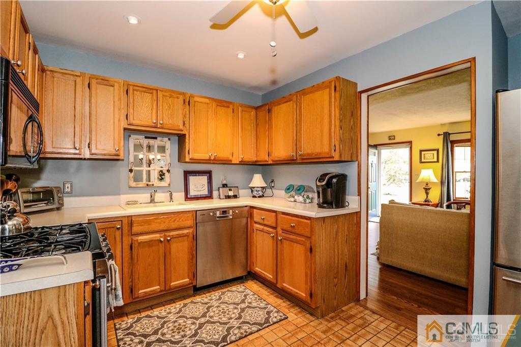 35 Stiles Road Edison, NJ 08817 - Photo 8 of 25 a kitchen with stainless steel appliances granite countertop a stove top oven a sink dishwasher and cabinets with wooden floor