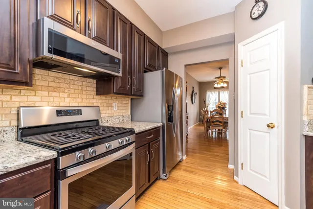 a kitchen with stainless steel appliances granite countertop a stove and a refrigerator