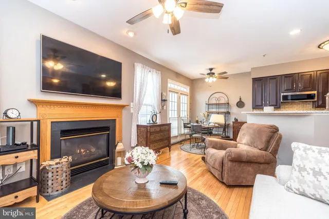 a living room with fireplace furniture and a chandelier