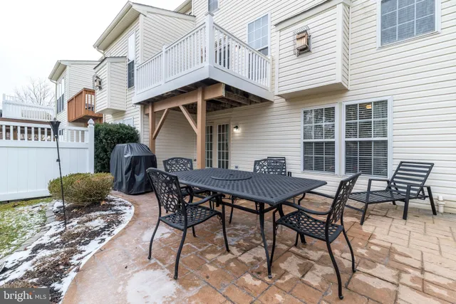 a view of a patio with table and chairs and wooden floor