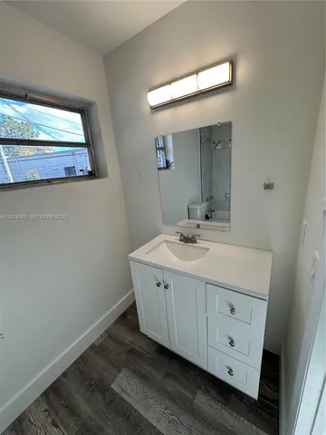 a bathroom with a double vanity sink and mirror