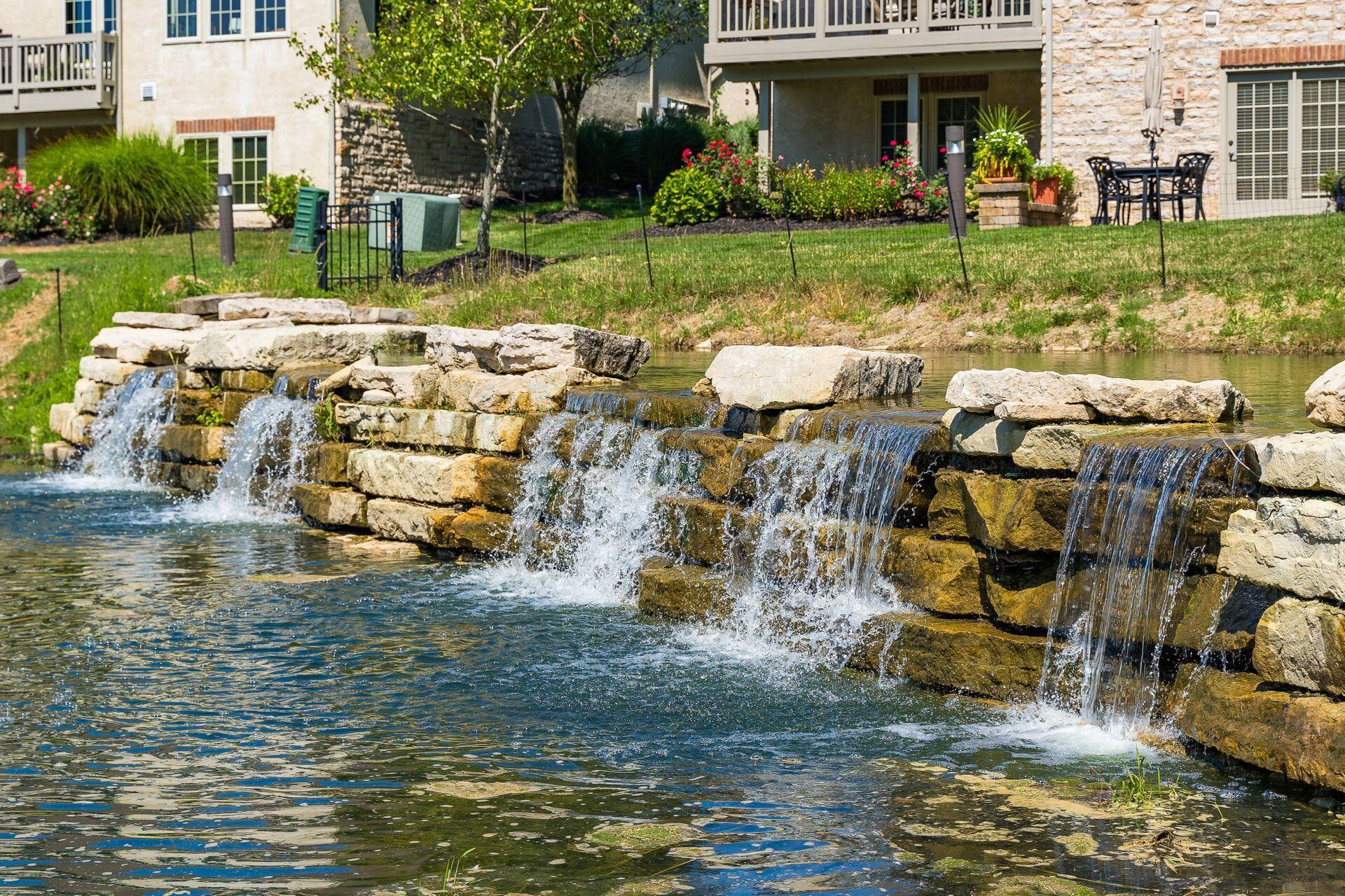 5475 Slater Ridge Westerville, OH 43082 - Photo 10 of 51 The gentle murmur of the waterfall fills the air with a calming, rhythmic melody, creating a soothing backdrop of nature’s own white noise.
