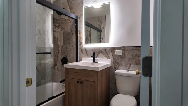 a bathroom with a shower and a sink