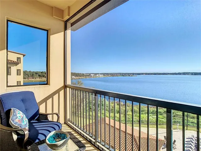 a view of a balcony with chair and wooden floor