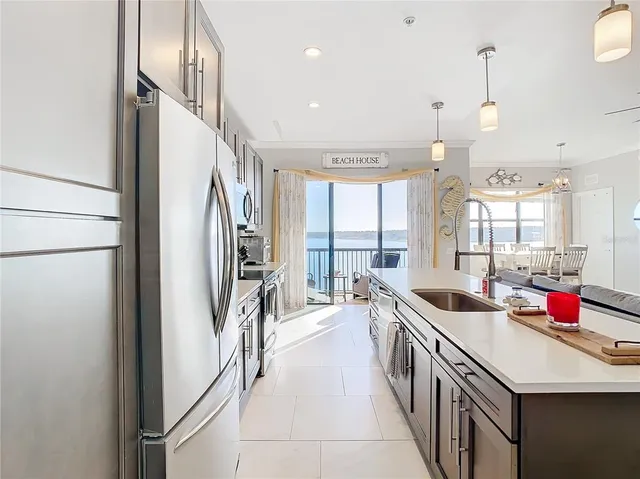 a kitchen with stainless steel appliances a sink stove and a refrigerator