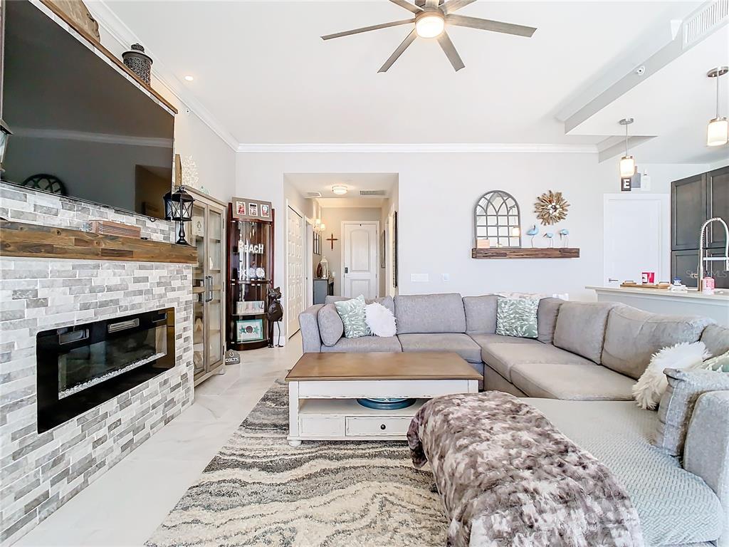 16300 County Road 455, Unit 610 Montverde, FL 34756 - Photo 4 of 22 a living room with furniture and a fireplace