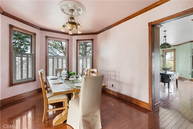 a spacious bedroom with a large bed and a chandelier
