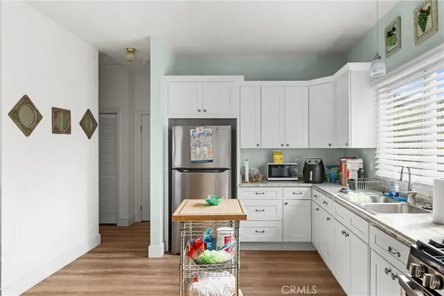 a front view of a house with a yard and potted plants