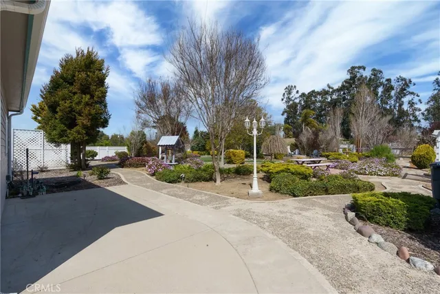 a front view of a house with swimming pool and sitting area