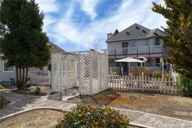 a front view of a house with swimming pool and porch