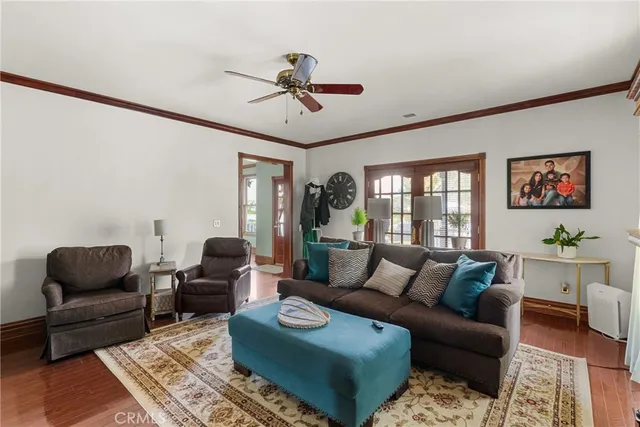 a large kitchen with stainless steel appliances granite countertop a stove a sink dishwasher and a dining table with wooden floor