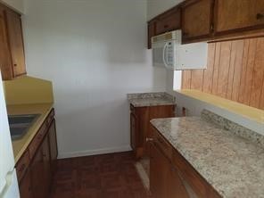 a kitchen with granite countertop cabinets appliances and a counter space