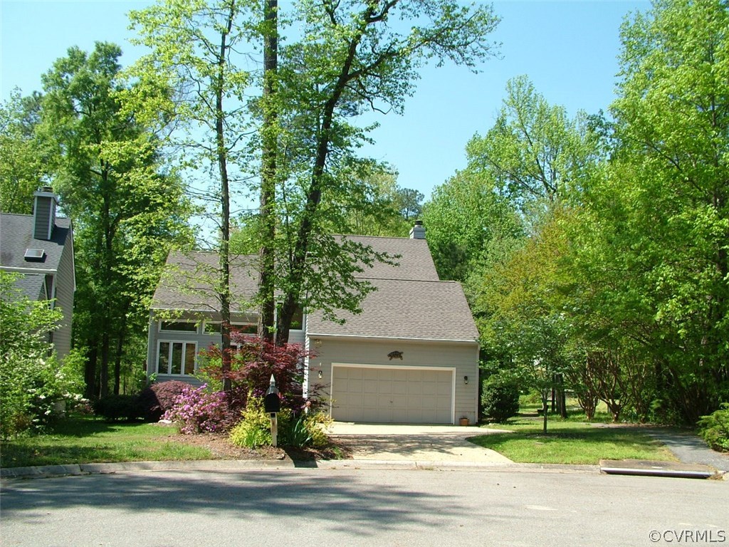 5721 Long Cove Road Midlothian, VA 23112 - Photo 3 of 42 a front view of a house with a garden