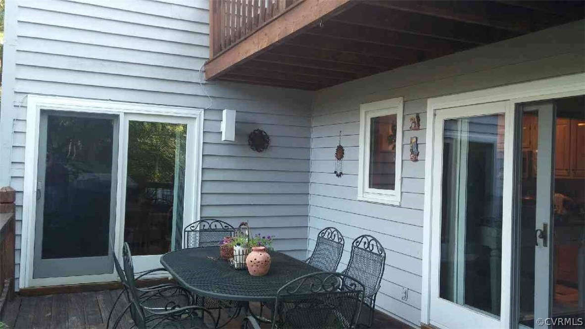 5721 Long Cove Road Midlothian, VA 23112 - Photo 9 of 42 a view of a porch with a table and chairs and potted plants