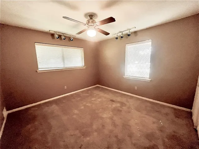 a view of yellow house with a yard