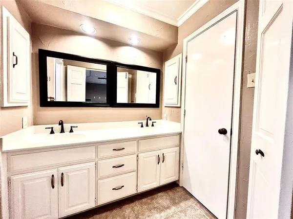 a bathroom with a double vanity sink and mirror