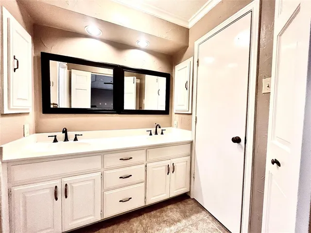 a bathroom with a double vanity sink and mirror