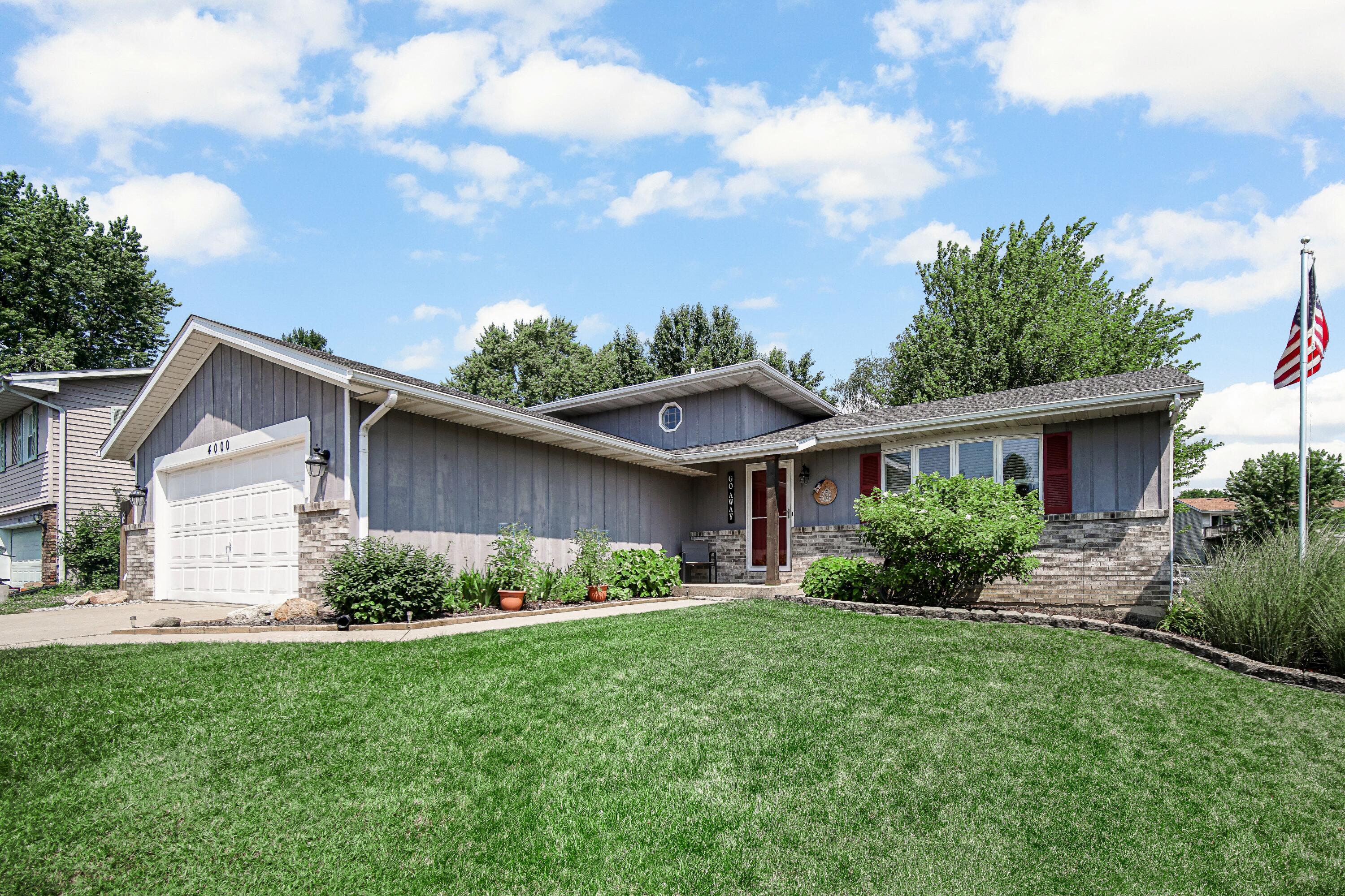 4000 Willowood Court Crown Point, IN 46307 - Photo 1 of 20 a front view of a house with a garden