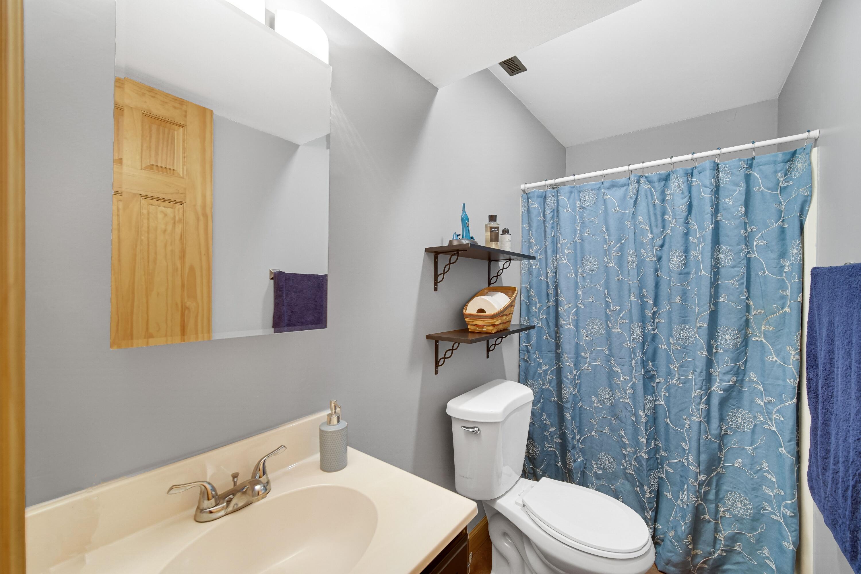 4000 Willowood Court Crown Point, IN 46307 - Photo 15 of 20 a bathroom with a toilet a sink and mirror