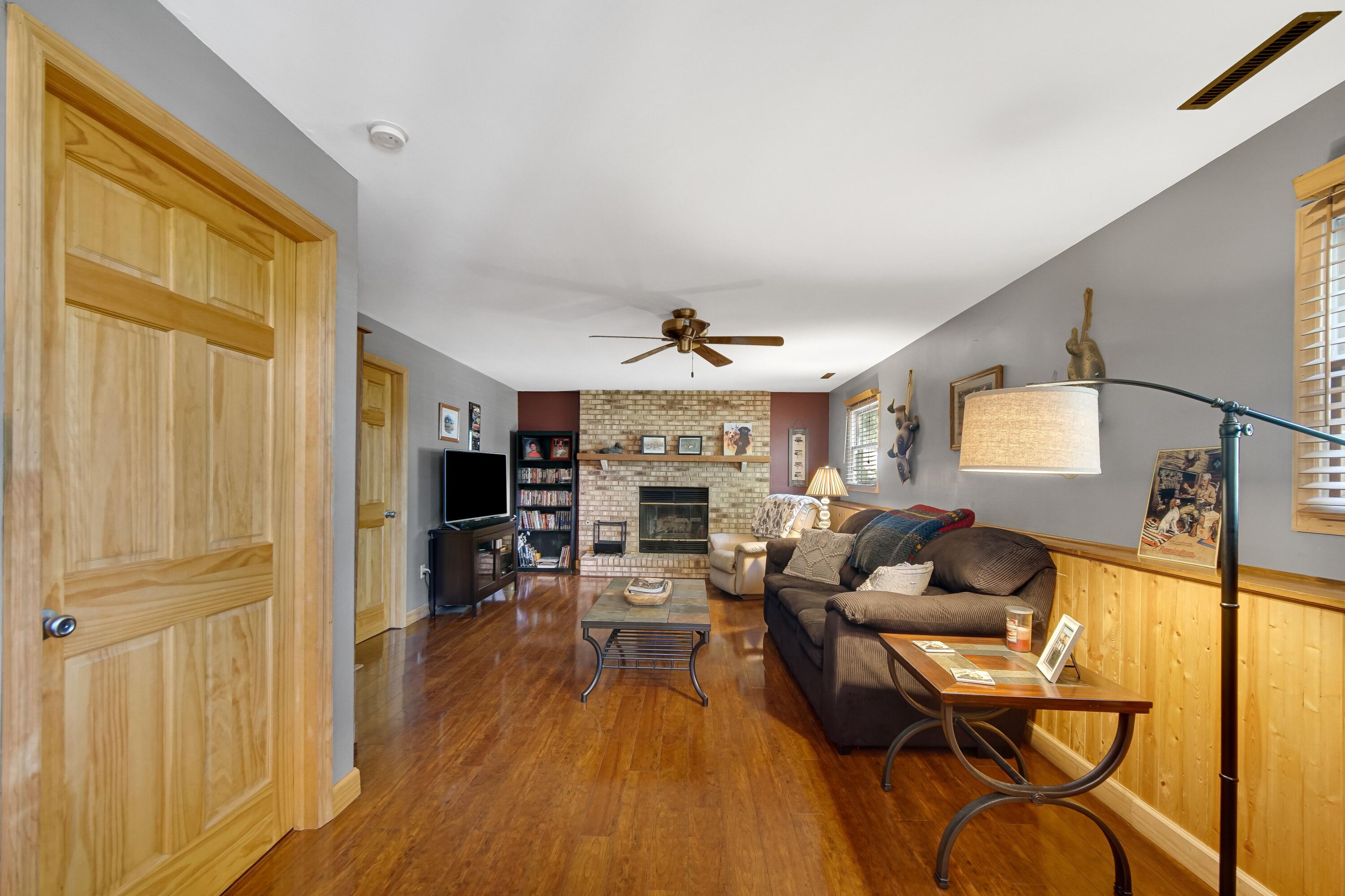 4000 Willowood Court Crown Point, IN 46307 - Photo 9 of 20 a living room with fireplace furniture and a wooden floor
