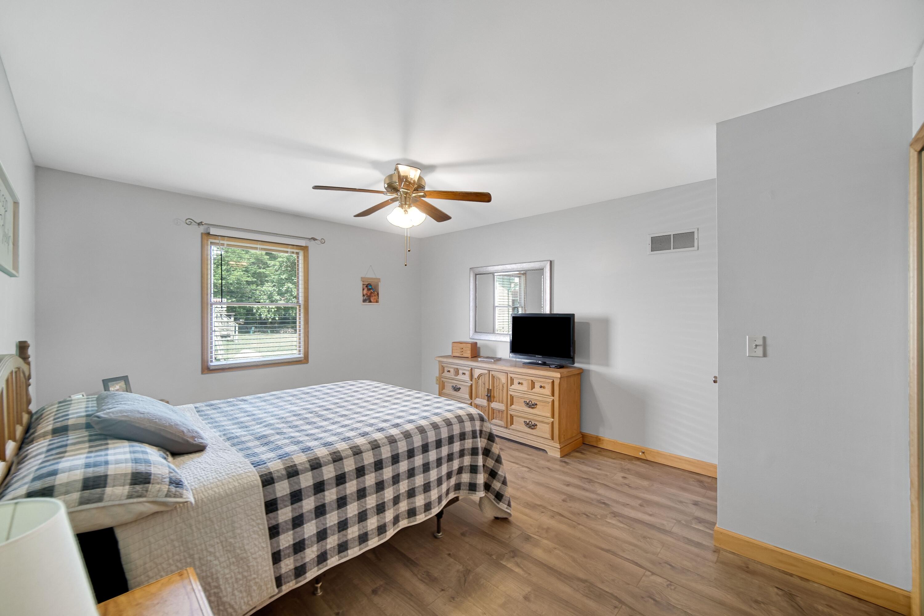 4000 Willowood Court Crown Point, IN 46307 - Photo 10 of 20 a bedroom with a bed and a flat screen tv