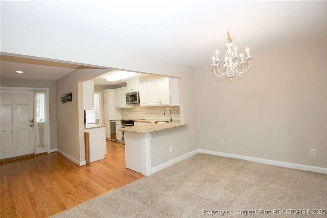 175 Knoll Road Southern Pines, NC 28387 - Photo 14 of 50 a kitchen with stainless steel appliances a refrigerator and a sink