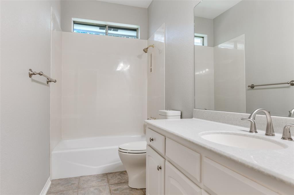 847 Turquoise Point Rockwall, TX 75032 - Photo 21 of 34 a bathroom with a sink toilet vanity and shower