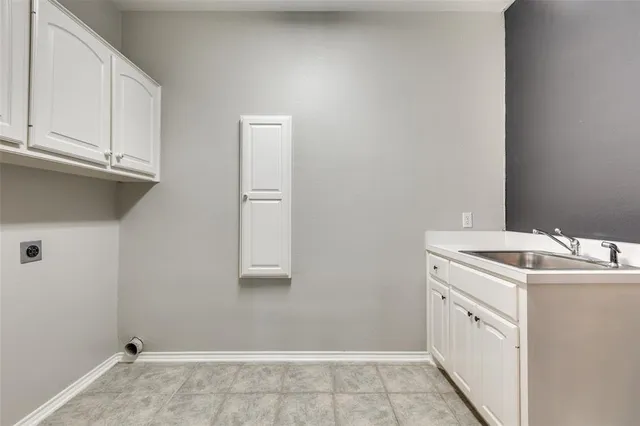 a utility room with cabinets washer and dryer