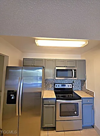 a kitchen with a stove and a microwave
