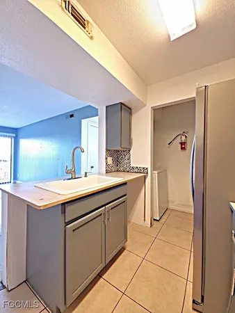 a kitchen with a sink cabinets and refrigerator