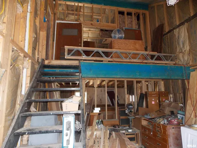 a view of a storage room with two windows