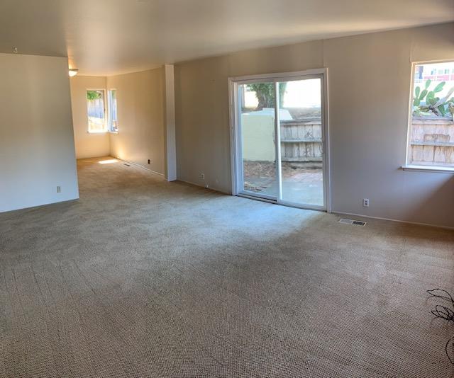829 Rosita Road Pacifica, CA 94044 - Photo 4 of 14 an empty room with windows and closet