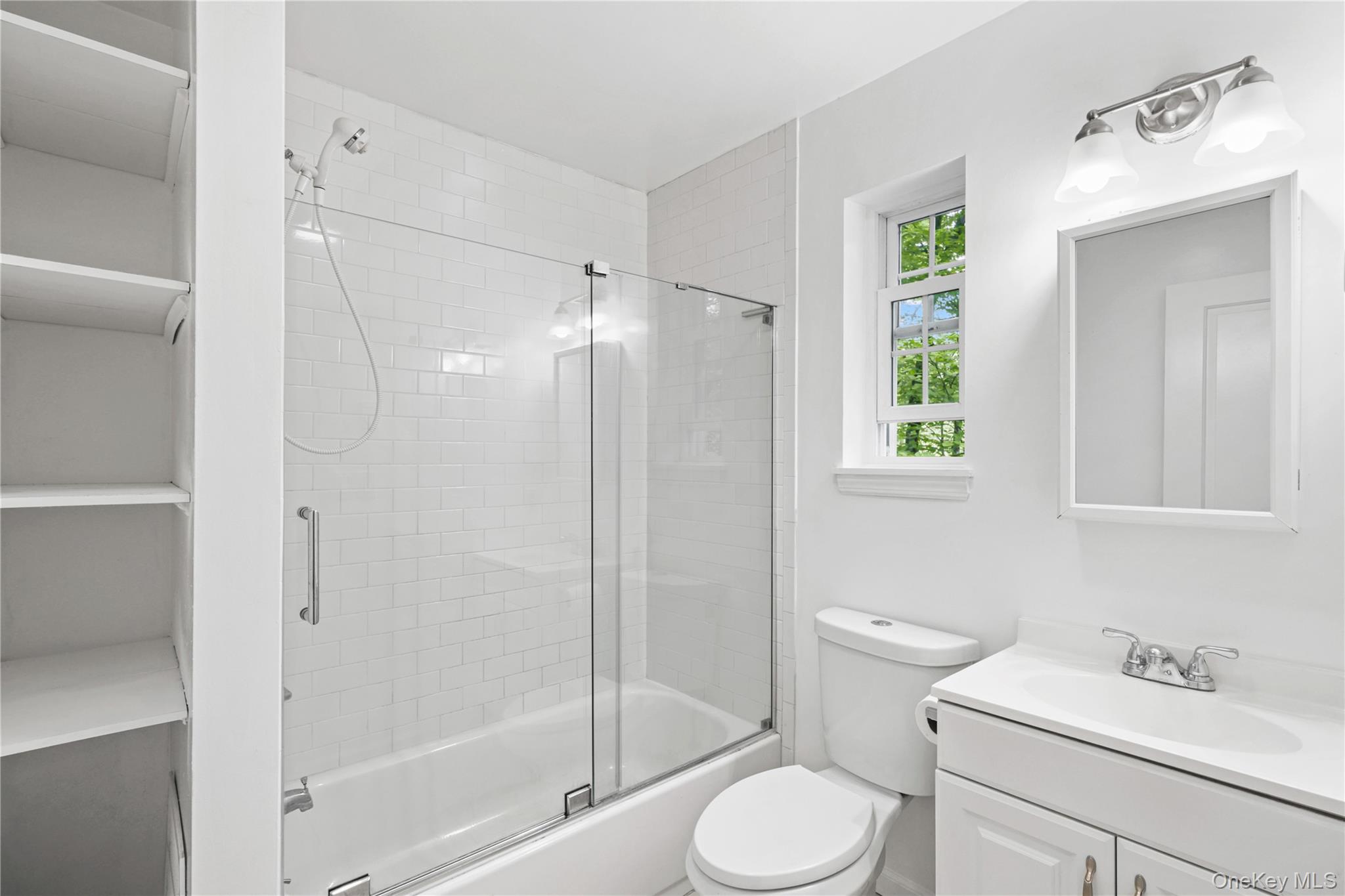 333 Wixon Pond Road Mahopac, NY 10541 - Photo 6 of 18 Bathroom with bath / shower combo with glass door, vanity, toilet plus storage.
