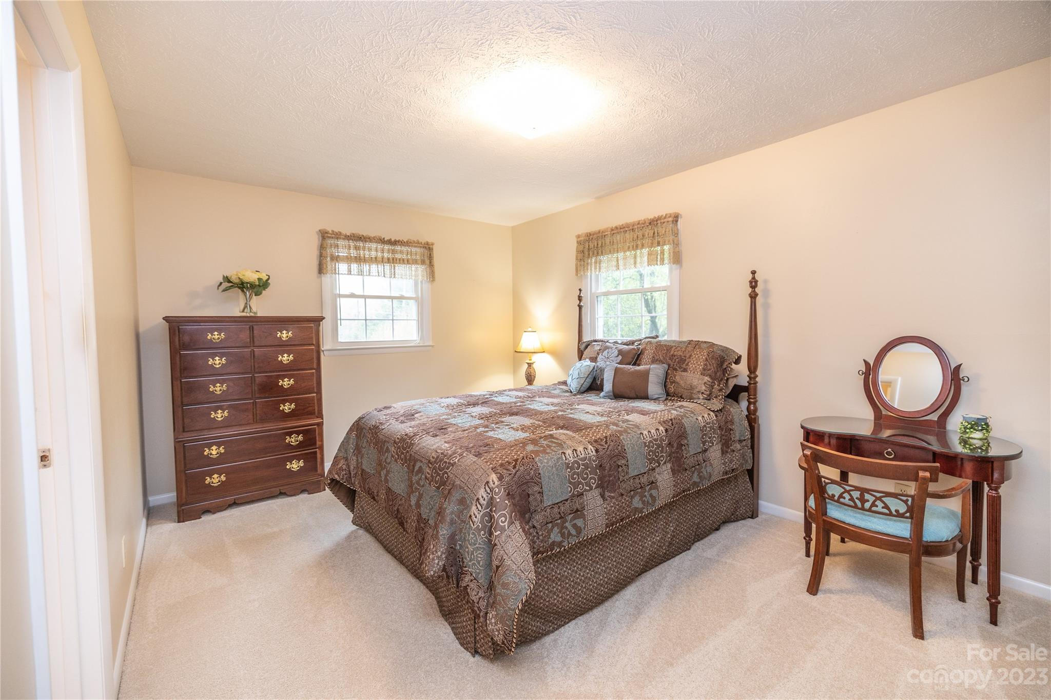 19 Norman Road Fletcher, NC 28732 - Photo 14 of 30 a spacious bedroom with a bed a dresser and chair