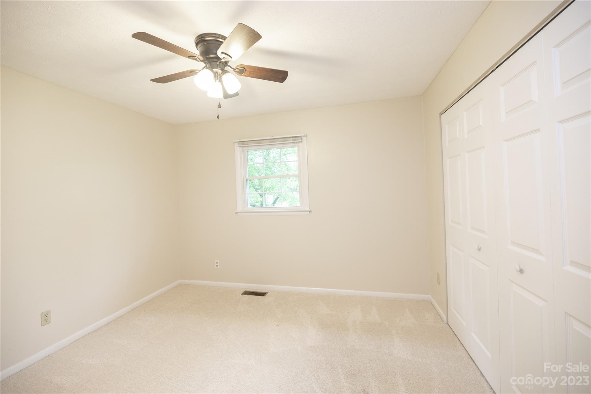 19 Norman Road Fletcher, NC 28732 - Photo 20 of 30 an empty room with a window and a fan