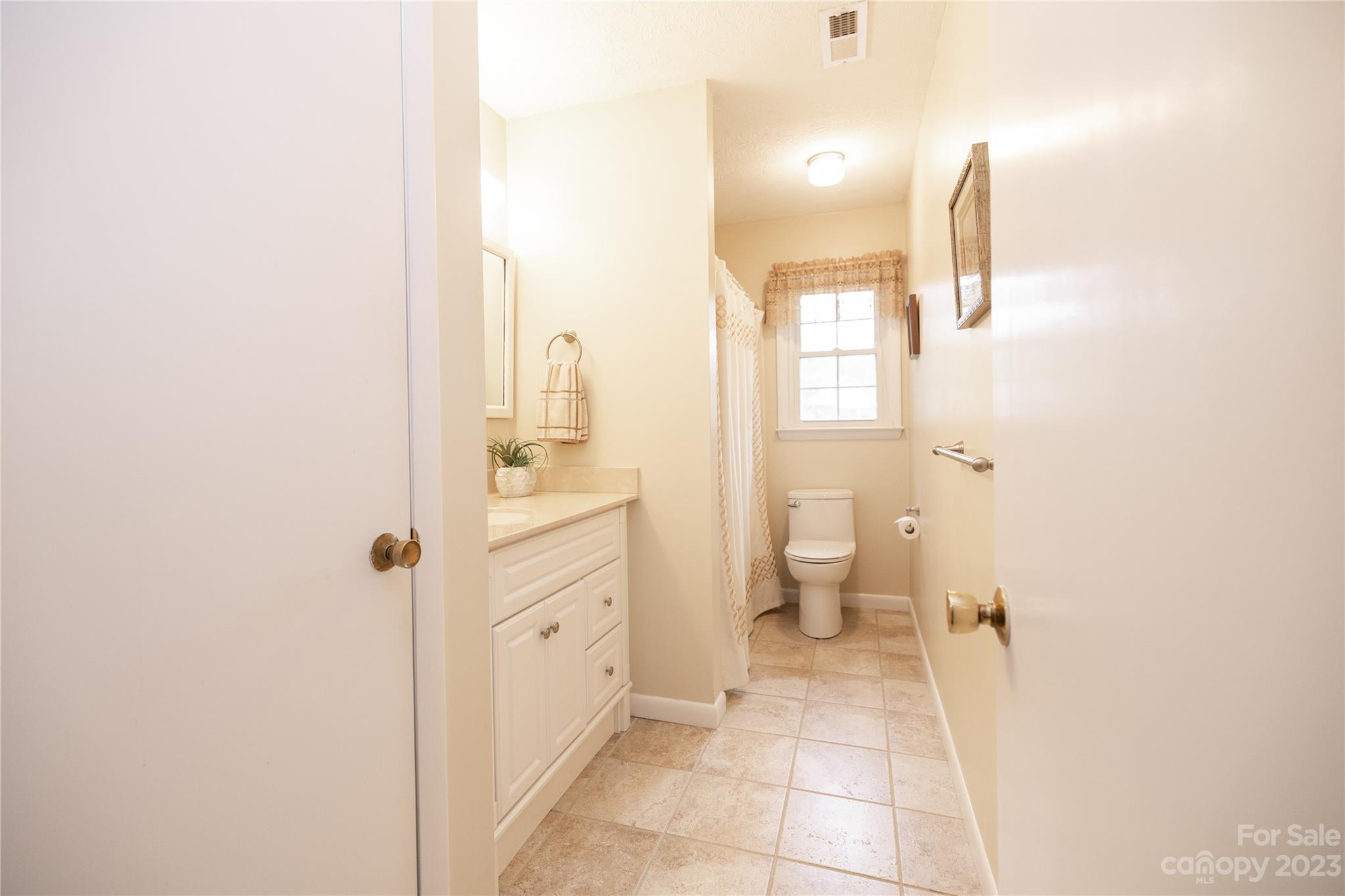 19 Norman Road Fletcher, NC 28732 - Photo 22 of 30 a bathroom with a sink and a mirror
