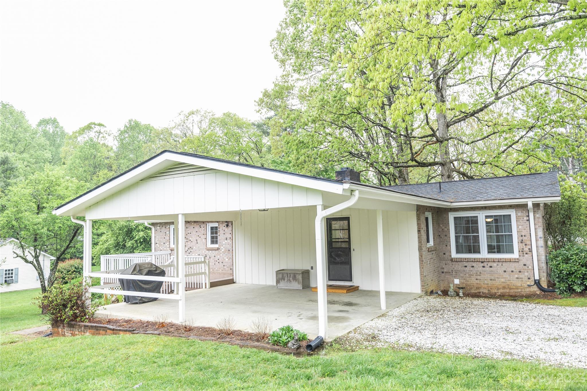 19 Norman Road Fletcher, NC 28732 - Photo 28 of 30 a front view of a house with a yard table and chairs