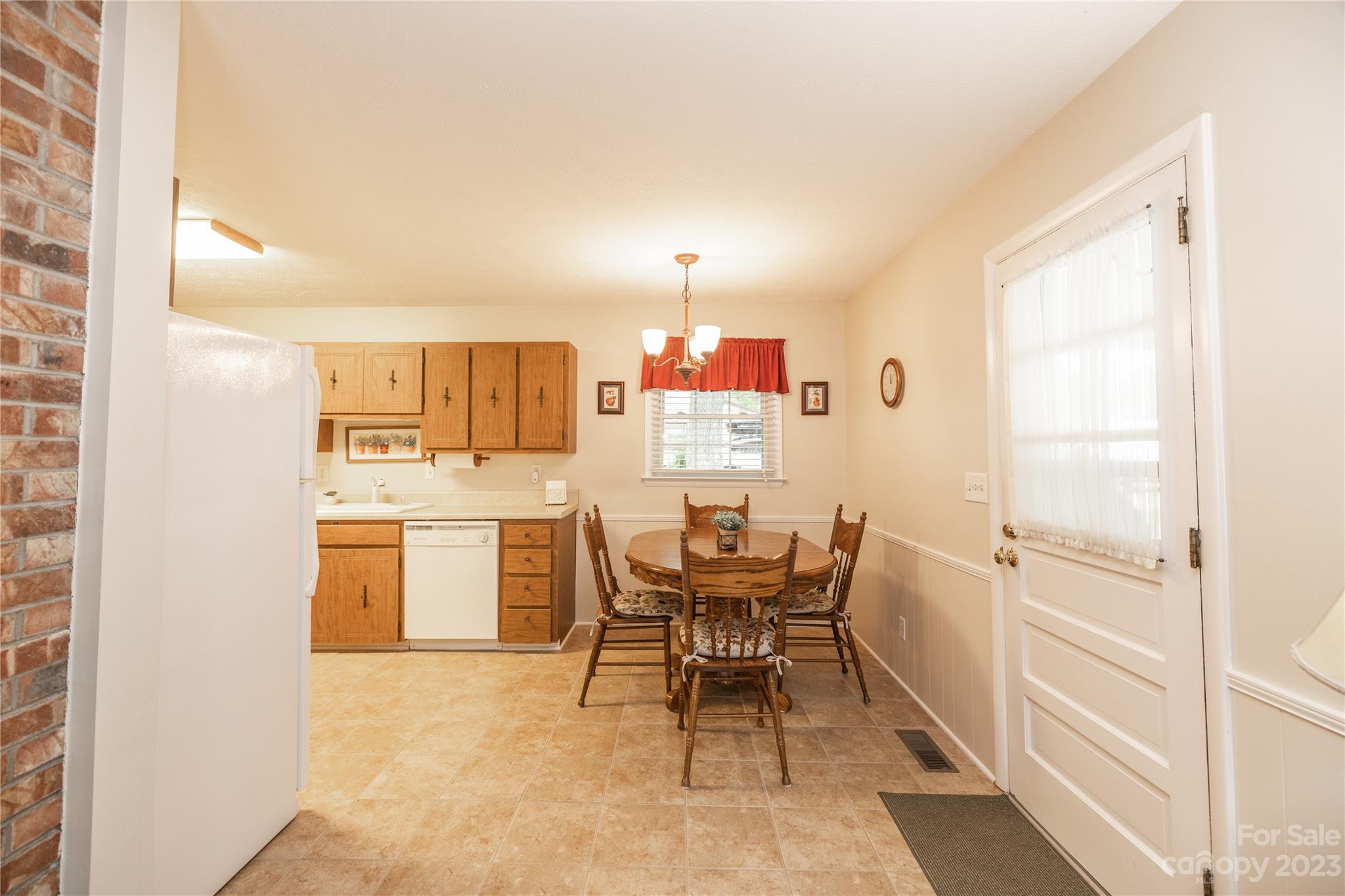 19 Norman Road Fletcher, NC 28732 - Photo 9 of 30 a kitchen with a refrigerator and table