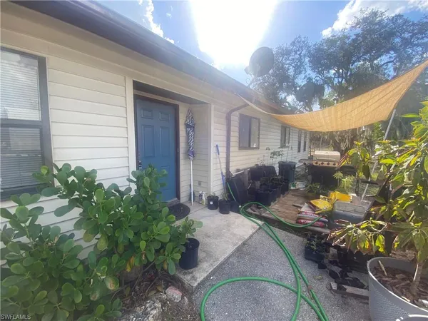 a view of a backyard with plants and outdoor seating
