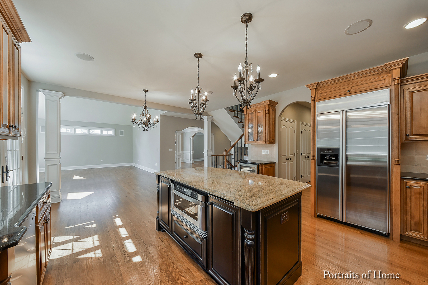 606 Wellner Road Naperville, IL 60540 - Photo 11 of 30 a kitchen with a sink chandelier and refrigerator