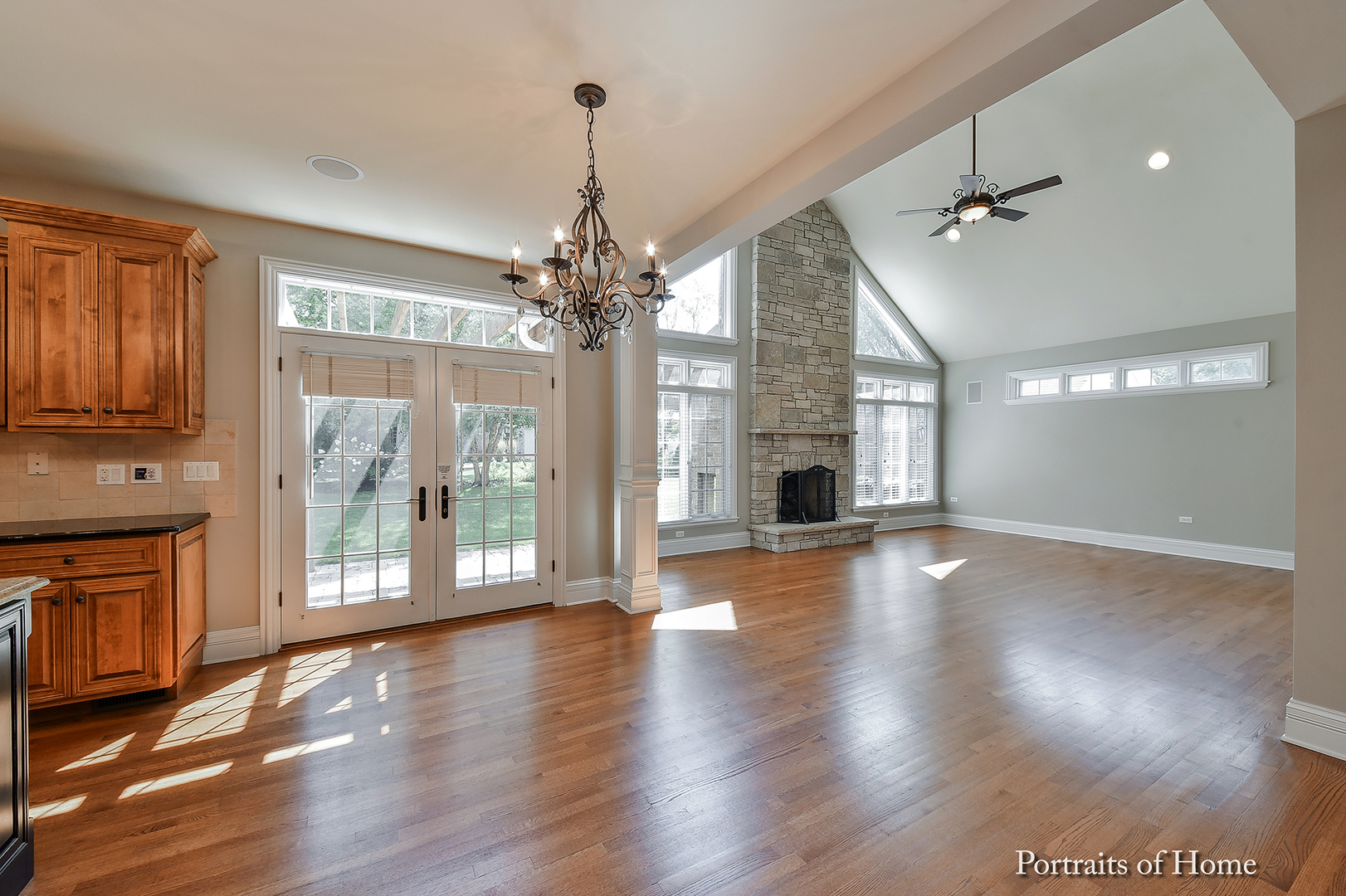 606 Wellner Road Naperville, IL 60540 - Photo 13 of 30 an empty room with wooden floor fireplace and windows