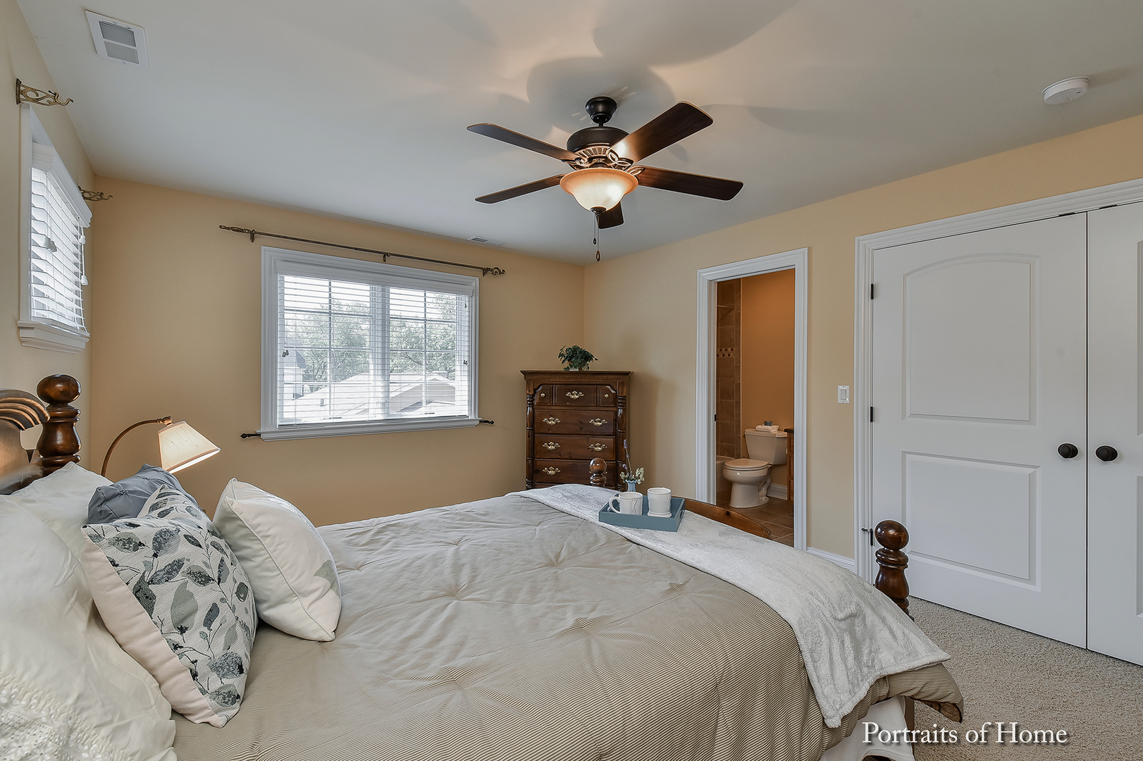 606 Wellner Road Naperville, IL 60540 - Photo 22 of 30 a bedroom with a bed and a chandelier