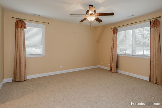 606 Wellner Road Naperville, IL 60540 - Photo 23 of 30 an empty room with a window and a fan