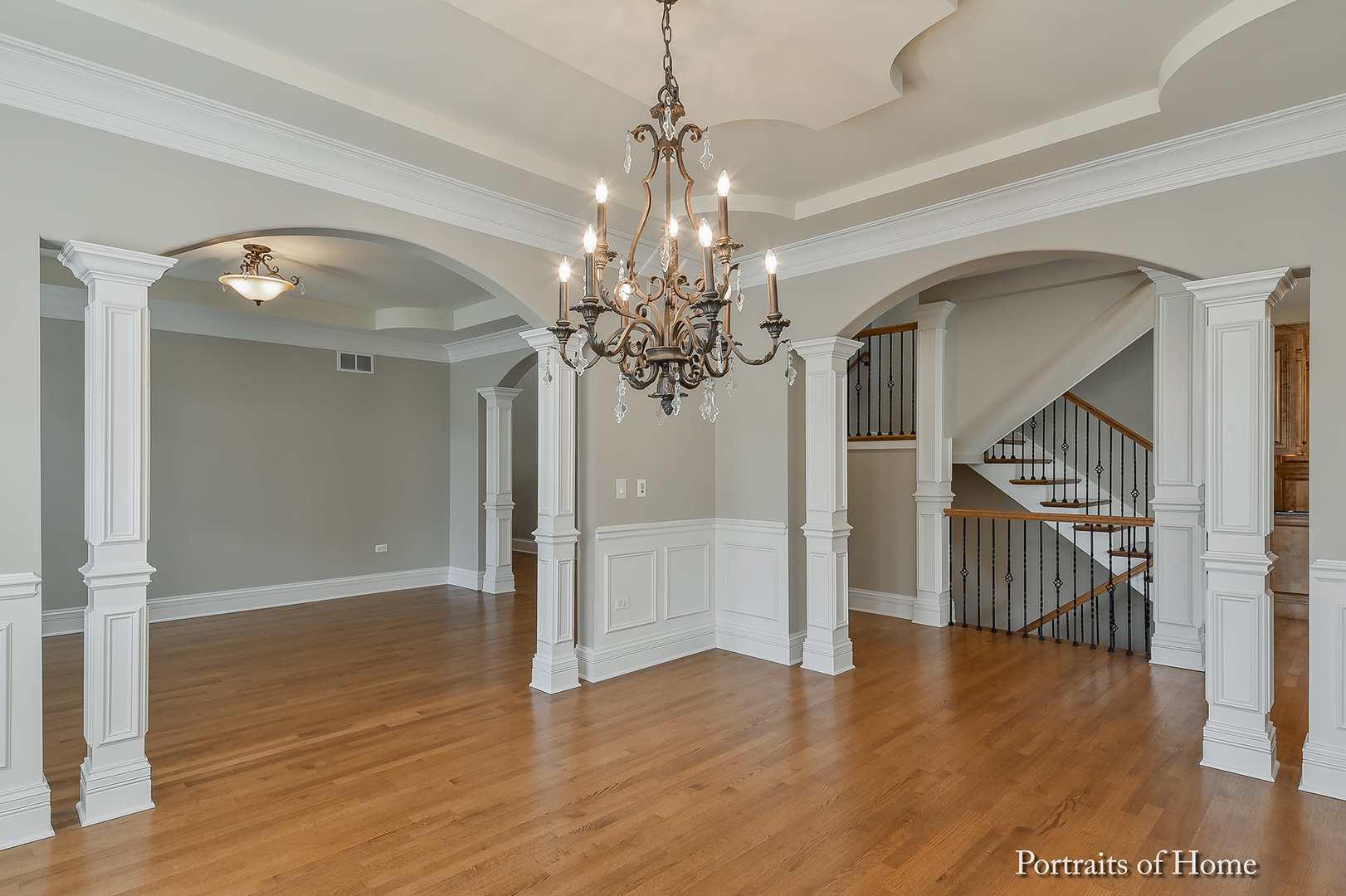 606 Wellner Road Naperville, IL 60540 - Photo 7 of 30 a view of a livingroom with wooden floor and a chandelier