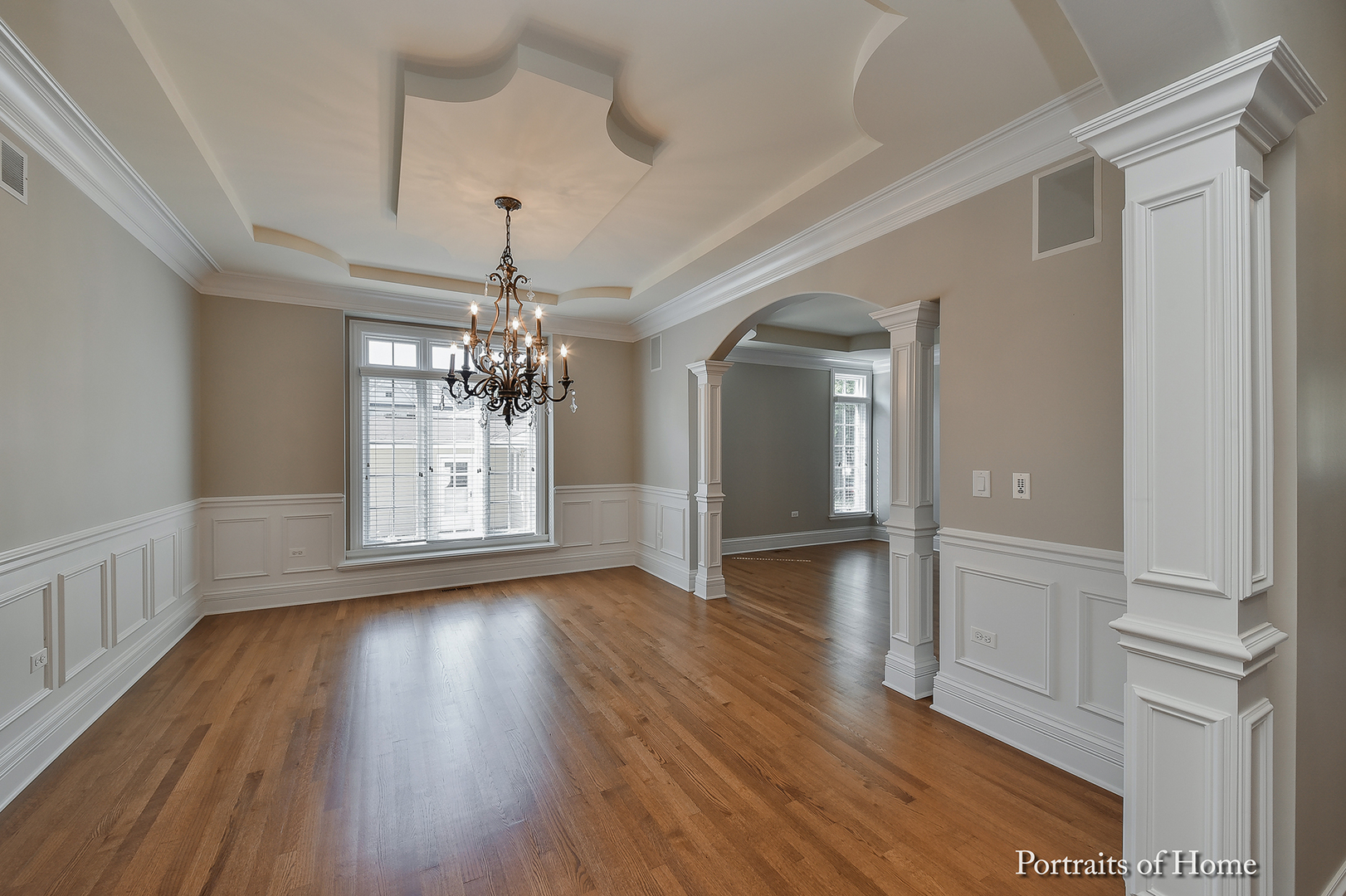 606 Wellner Road Naperville, IL 60540 - Photo 8 of 30 a view of a room with wooden floor chandelier and windows
