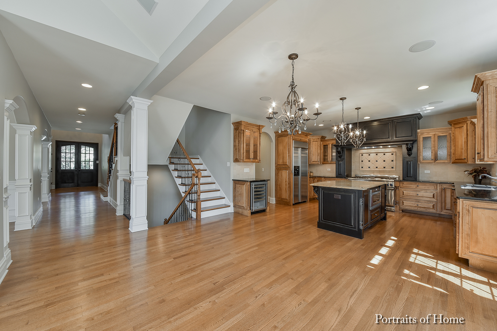606 Wellner Road Naperville, IL 60540 - Photo 9 of 30 a view of a dining room and livingroom with furniture wooden floor a chandelier